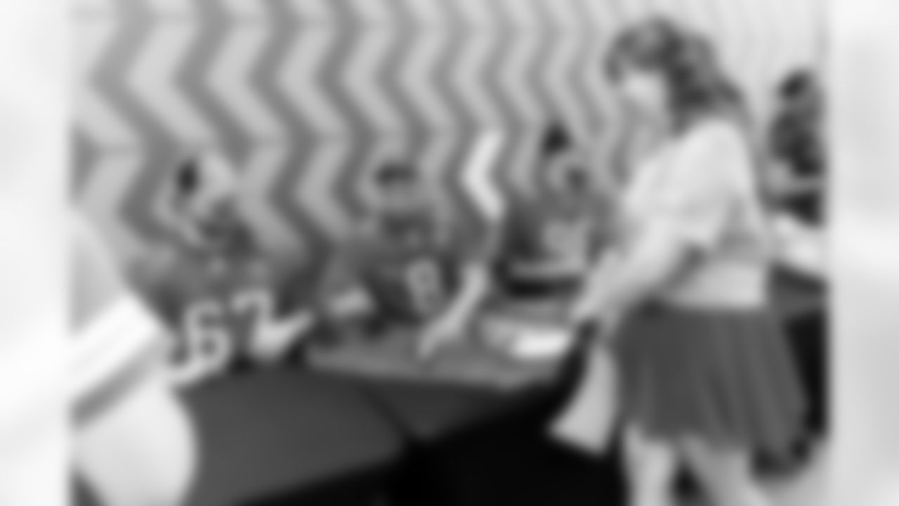 TAMPA, FL - December 02, 2025 - Guard Luke Goedeke #67, Inside Linebacker SirVocea Dennis #8, and Outside Linebacker Anthony Nelson #98 of the Tampa Bay Buccaneers during a visit to MacDill Air Force Base. Photo By Kyle Zedaker/Tampa Bay Buccaneers