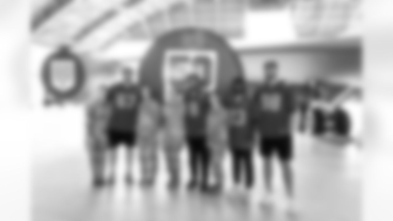 TAMPA, FL - December 02, 2025 - Guard Luke Goedeke #67, Inside Linebacker SirVocea Dennis #8, Safety Tykee Smith #23, and Outside Linebacker Anthony Nelson #98 of the Tampa Bay Buccaneers during a visit to MacDill Air Force Base. Photo By Kyle Zedaker/Tampa Bay Buccaneers