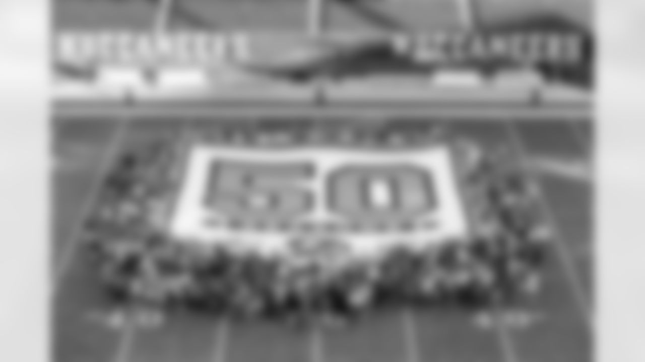 TAMPA, FL - November 30, 2025 - 50 year season pass members at midfield after the game between the Arizona Cardinals and Tampa Bay Buccaneers. The Bucs won the game, 20-17. Photo By Dave Pullis/Tampa Bay Buccaneers