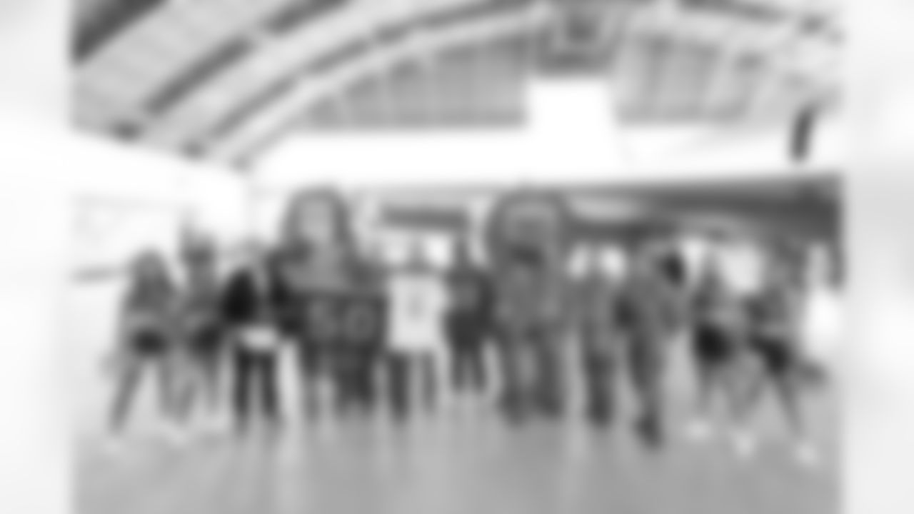 TAMPA, FL - December 02, 2025 - Tampa Bay Buccaneers Cheerleaders, Brian Ford, Outside Linebacker Anthony Nelson #98, Inside Linebacker SirVocea Dennis #8, Safety Tykee Smith #23, and Guard Luke Goedeke #67 of the Tampa Bay Buccaneers during a visit to MacDill Air Force Base. Photo By Kyle Zedaker/Tampa Bay Buccaneers