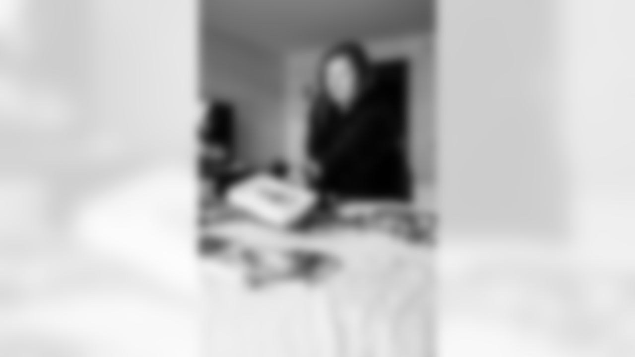 INDIANAPOLIS, IN - February 23, 2026 - Scouting Coordinator Peighton Roth passes out books and credentials for the 2026 NFL Combine at Lucas Oil Stadium. Photo By Tori Richman/Tampa Bay Buccaneers