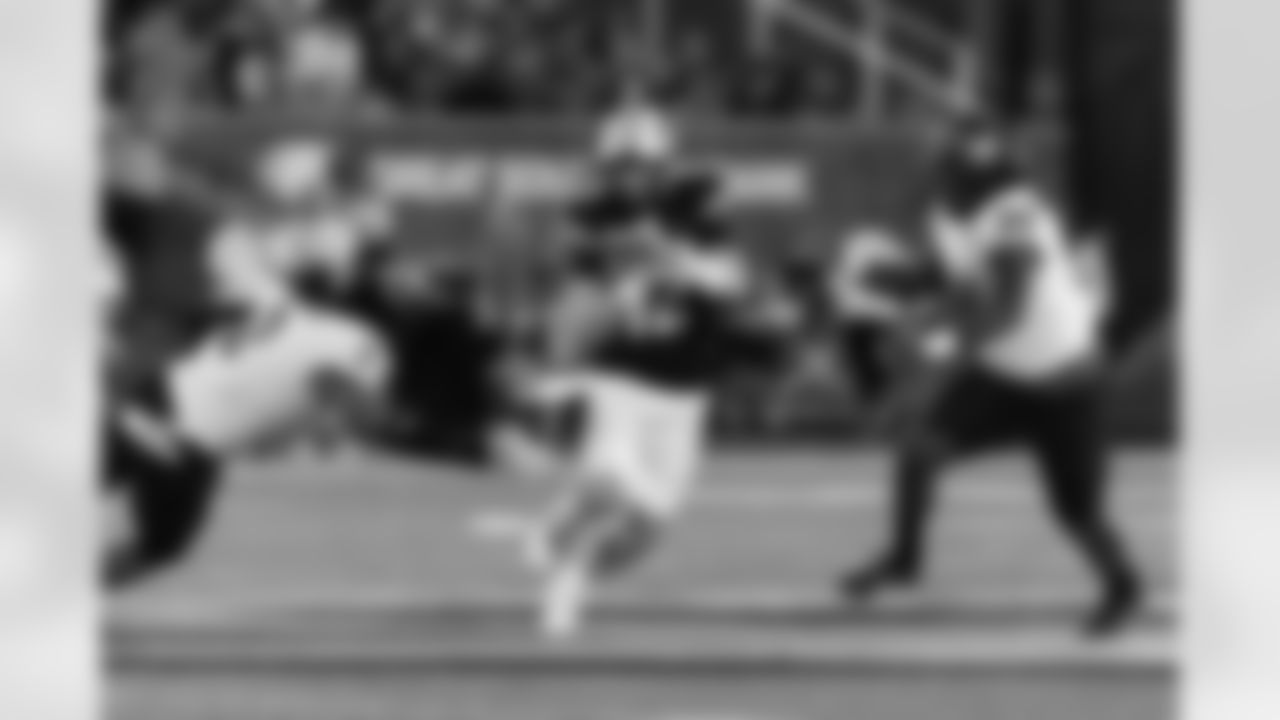 Missouri quarterback Brady Cook, center, runs between Buffalo's Red Murdock, left, and Daishon Folsom, right, during the first half of an NCAA college football game Saturday, Sept. 7, 2024, in Columbia, Mo. (AP Photo/L.G. Patterson)
