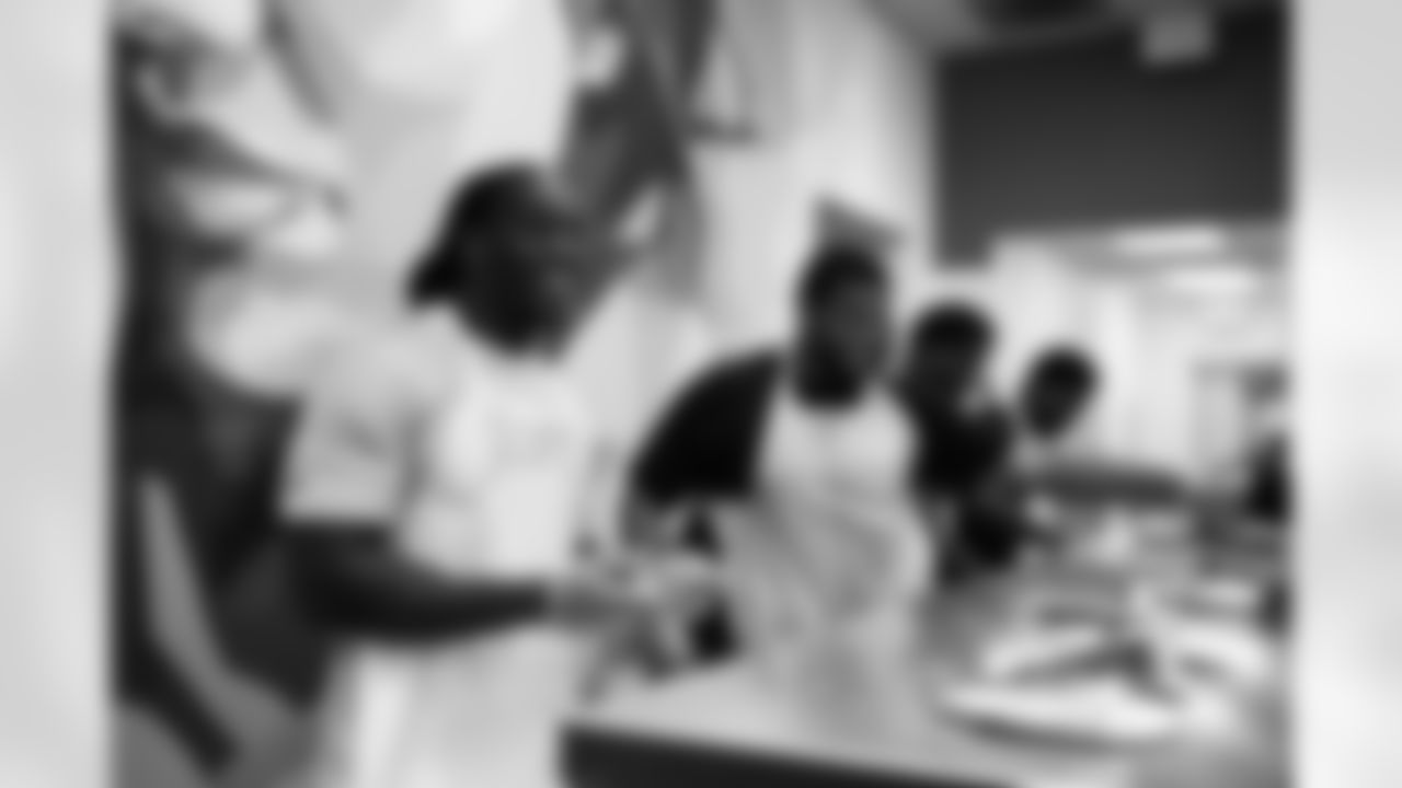 The Arizona Cardinals defensive line serves food at Phoenix Rescue Mission on Tuesday, Sep. 17, 2024 in Phoenix, AZ.