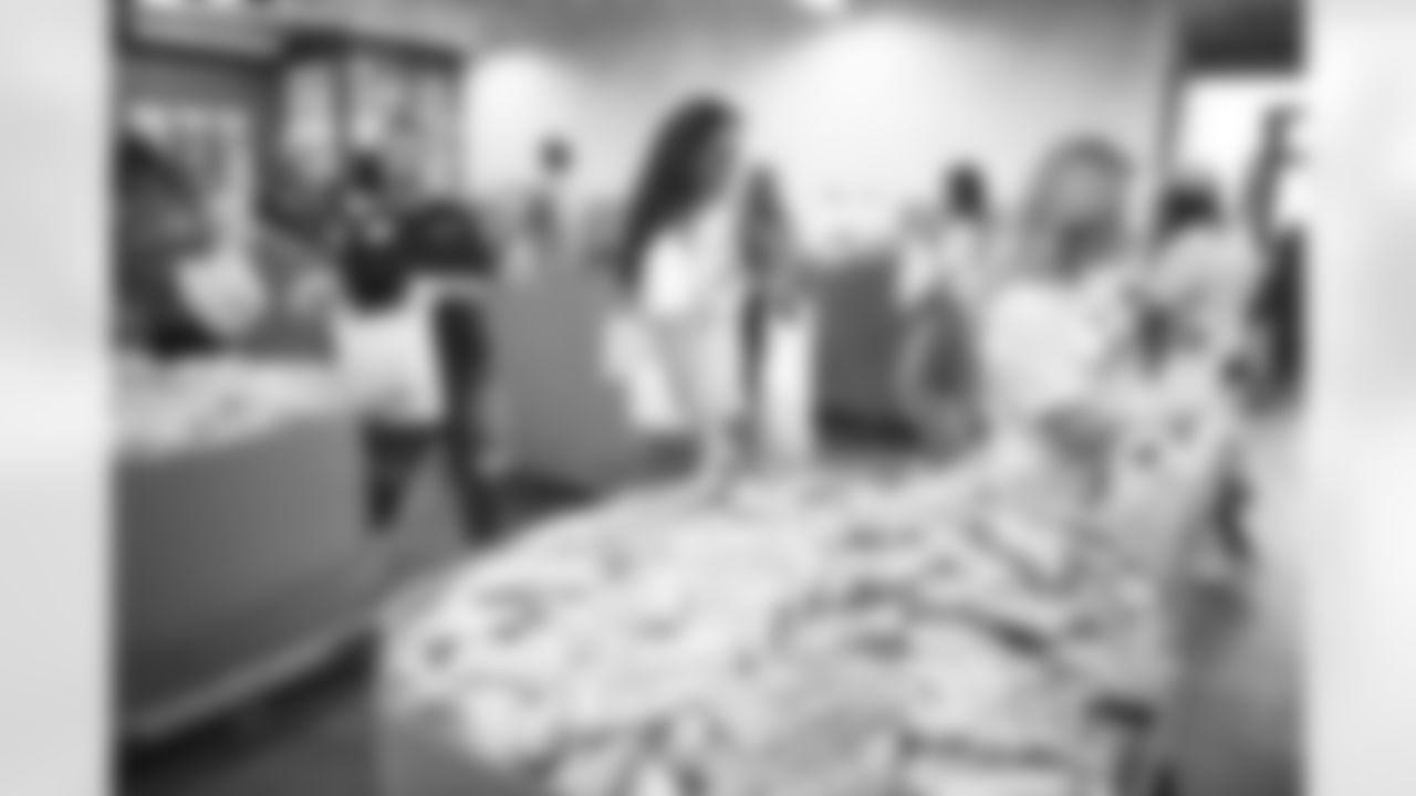 The Arizona Cardinals Women's Club packs emergency food bags at United Food Bank on Thursday, November 16, 2023 in Mesa, AZ.
