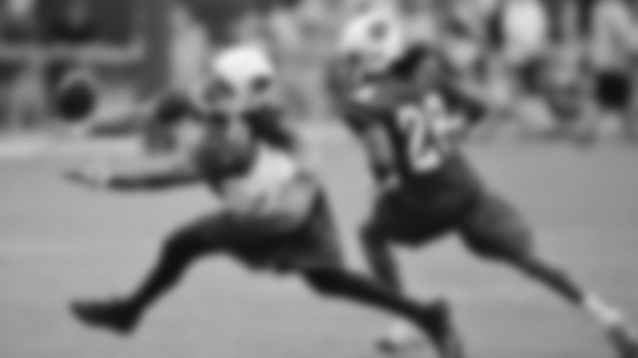 Larry Fitzgerald reaches for a pass during training camp in Flagstaff in 2011.