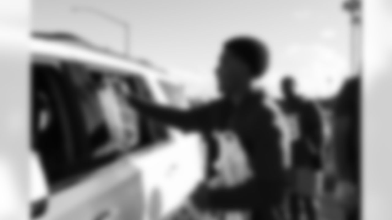 Arizona Cardinals offensive lineman Kelvin Beachum (68) and Arizona Cardinals offensive lineman Paris Johnson Jr. (70) host a food distribution for families at the Eisenhower Center for Innovation in collaboration with United Food Bank on Tuesday, Nov. 18, 2025 in Mesa, AZ.