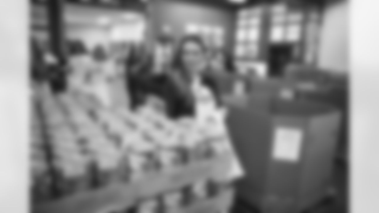 The Arizona Cardinals Women's Club packs emergency food bags at United Food Bank on Thursday, November 16, 2023 in Mesa, AZ.