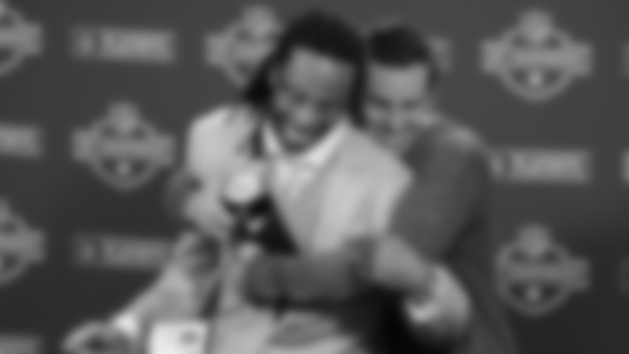 Kurt Warner hugs Larry Fitzgerald during a press conference after the NFC Championship in 2008.