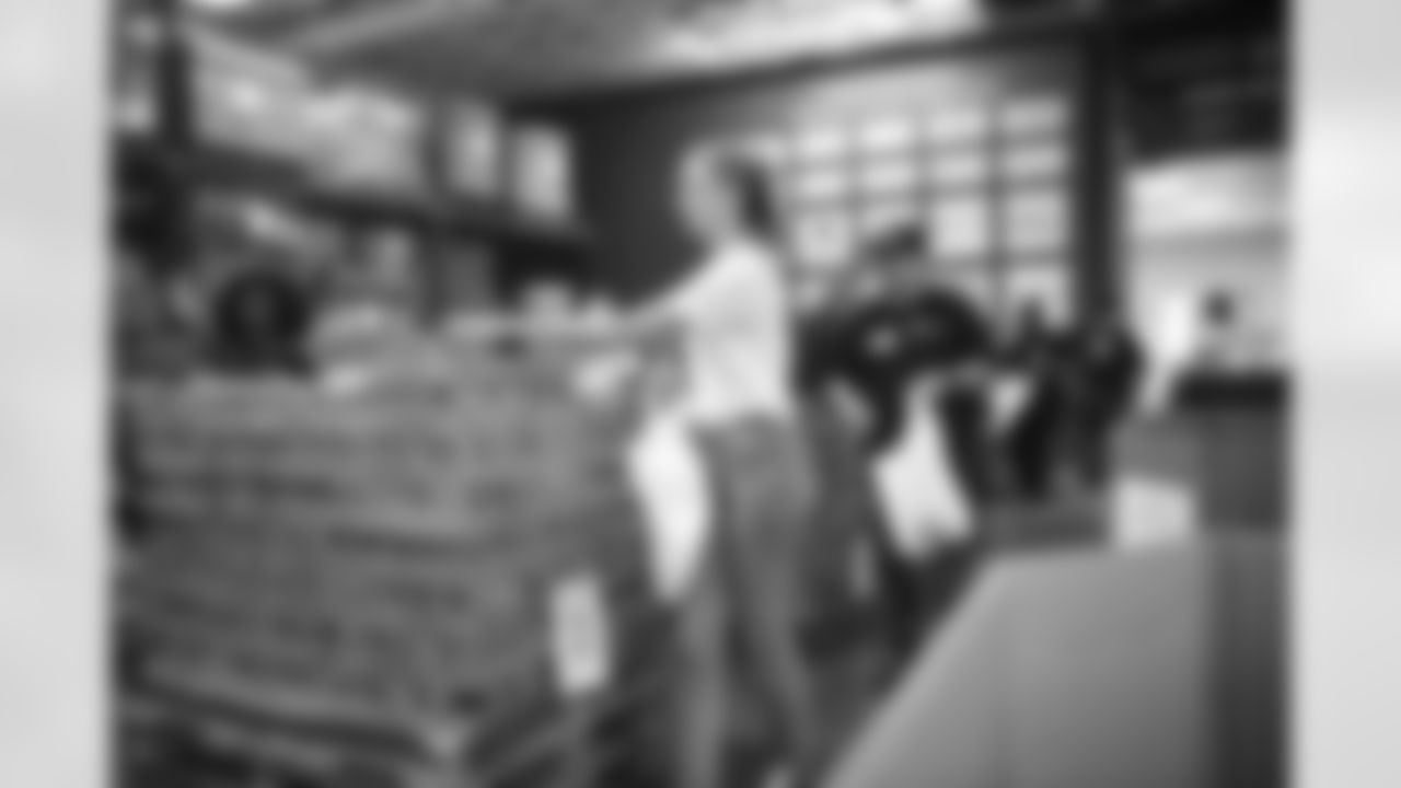 The Arizona Cardinals Women's Club packs emergency food bags at United Food Bank on Thursday, November 16, 2023 in Mesa, AZ.