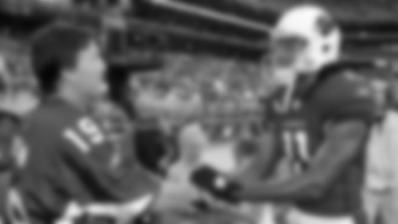 Larry Fitzgerald and NHL star Shane Doan speak before a game in 2010.