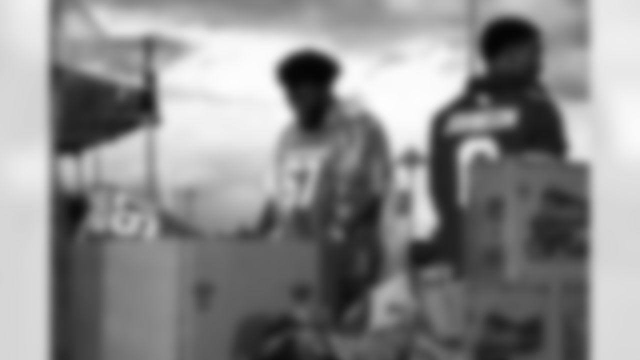 Arizona Cardinals offensive lineman Kelvin Beachum (68) and Arizona Cardinals offensive lineman Paris Johnson Jr. (70) host a food distribution for families at the Eisenhower Center for Innovation in collaboration with United Food Bank on Tuesday, Nov. 18, 2025 in Mesa, AZ.