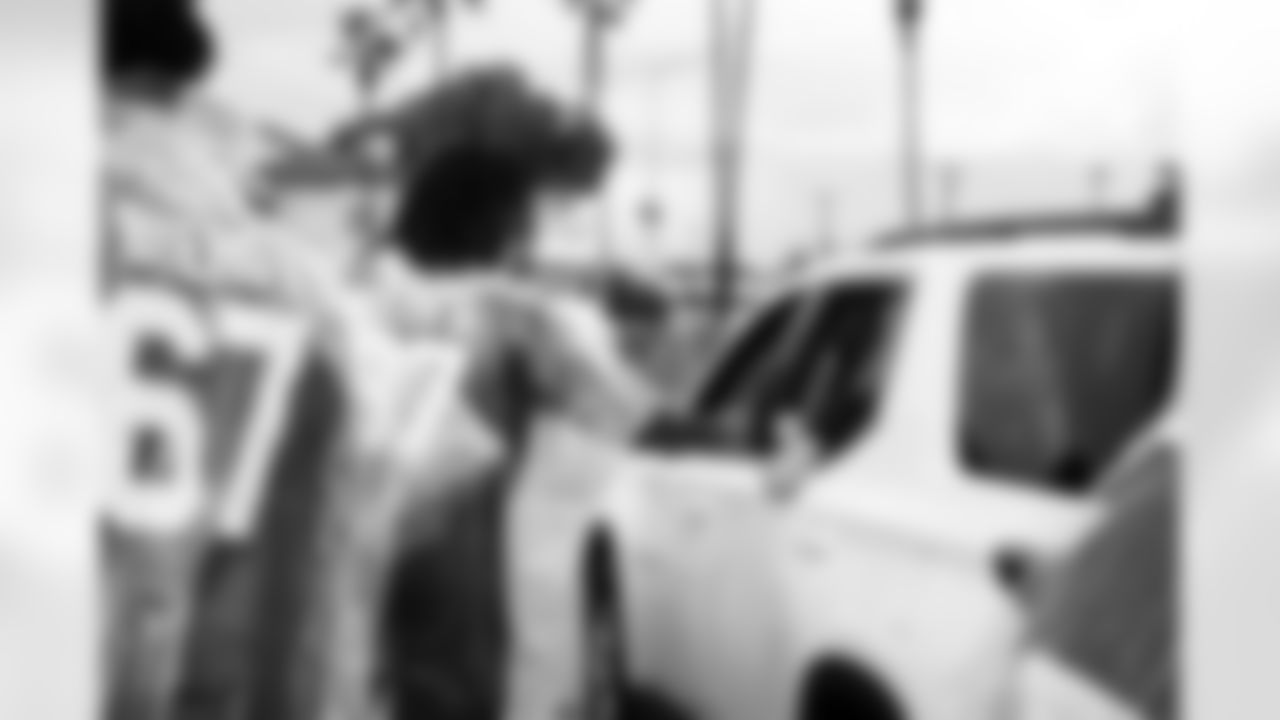 Arizona Cardinals offensive lineman Kelvin Beachum (68) and Arizona Cardinals offensive lineman Paris Johnson Jr. (70) host a food distribution for families at the Eisenhower Center for Innovation in collaboration with United Food Bank on Tuesday, Nov. 18, 2025 in Mesa, AZ.