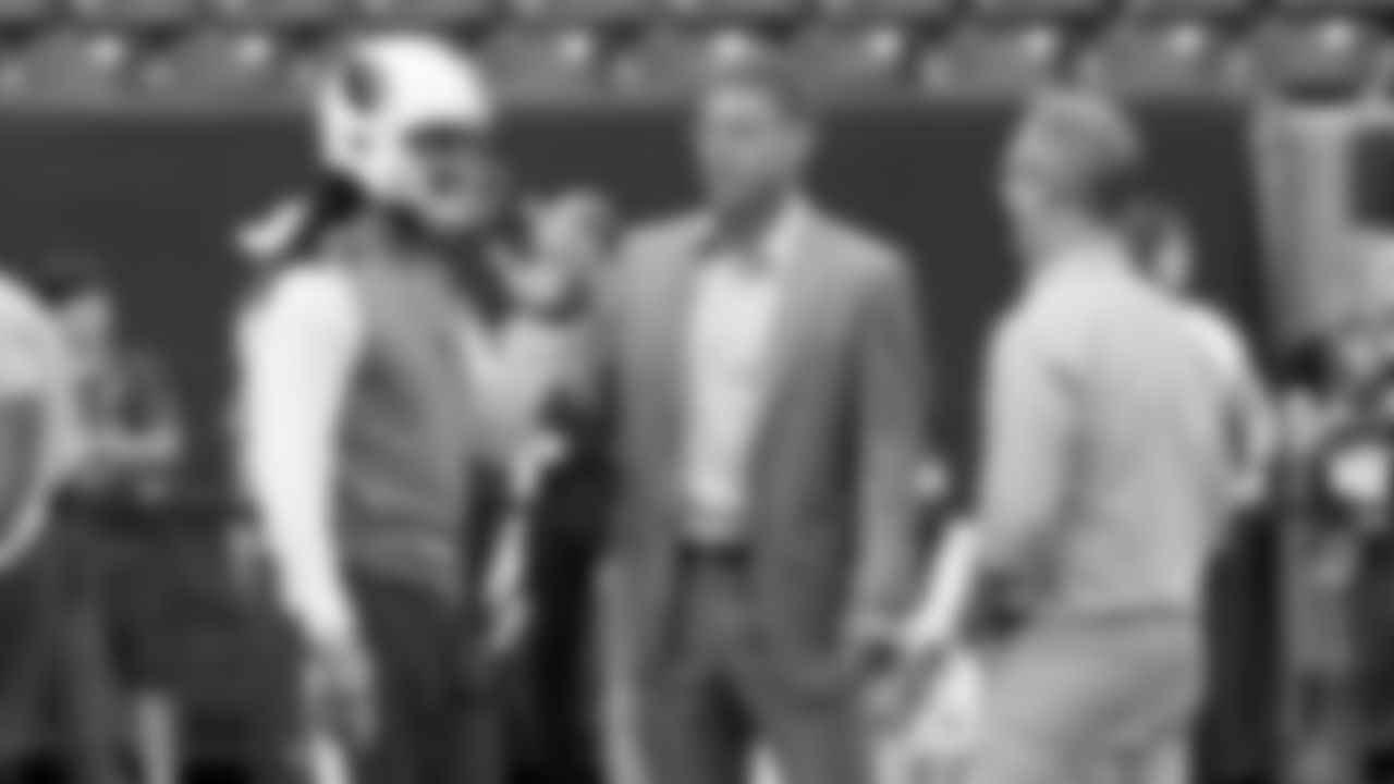 Larry Fitzgerald talks with announcers Troy Aikman and Joe Buck before a game in 2016.