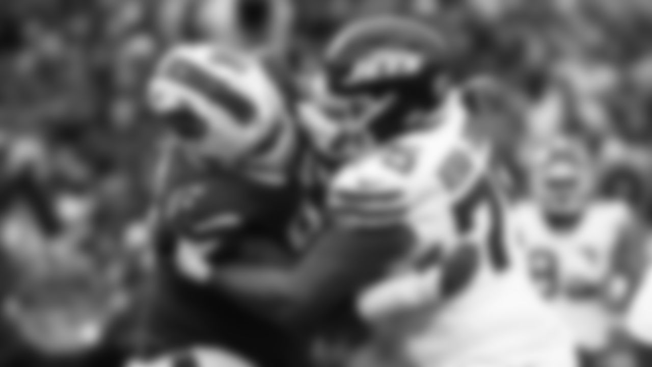 Buffalo Bills defensive tackle Jordan Phillips (97) and New York Jets guard Alijah Vera-Tucker (75) battle for position during the second half of an NFL football game in Orchard Park, N.Y., Sunday Dec. 29, 2024. (AP Photo/ Jeffrey T. Barnes)