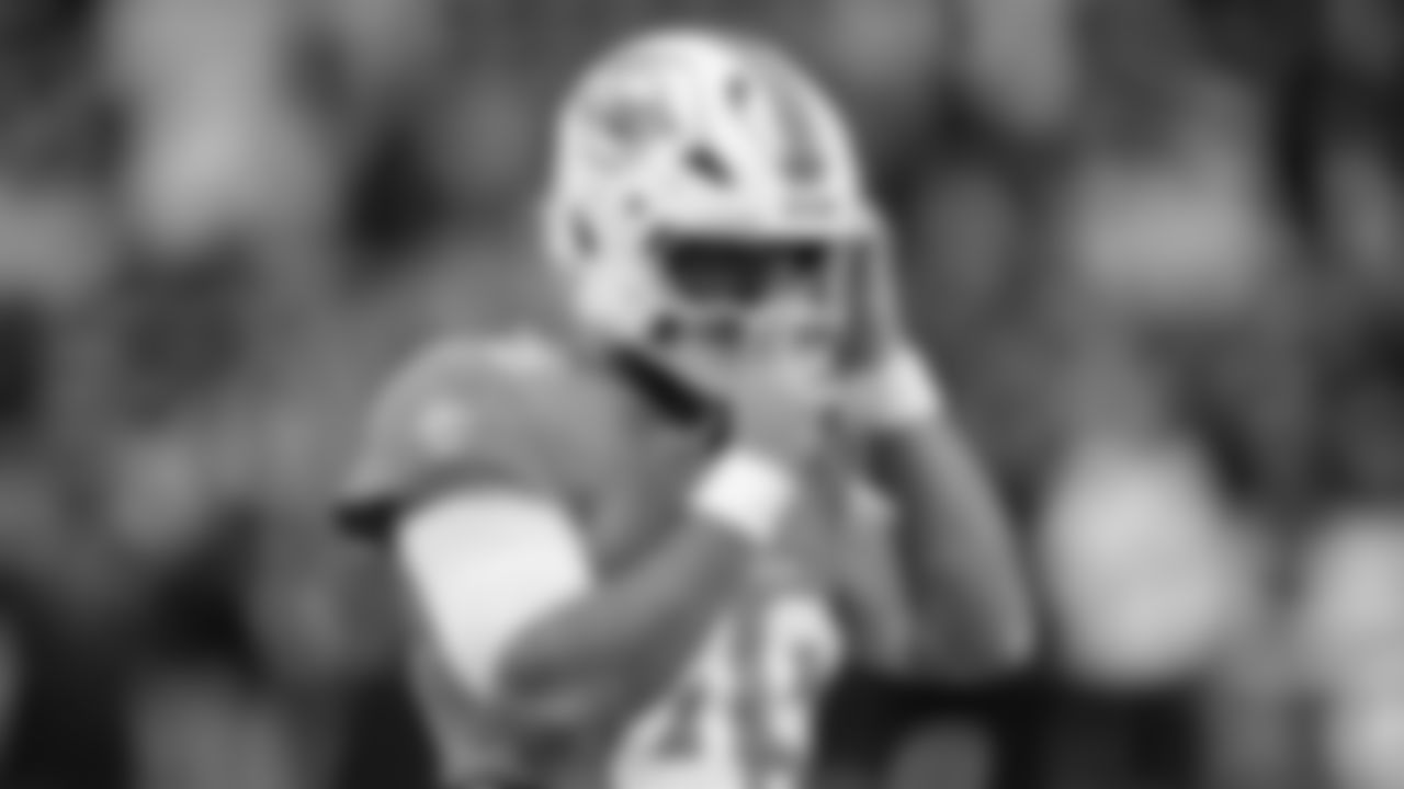 Miami Dolphins long snapper Joe Cardona (49) adjusts his helmet as he warms-up before an NFL football game between the Washington Commanders and the Miami Dolphins in Madrid, Spain, Sunday, Nov. 16, 2025. (AP Photo/Manu Fernandez)