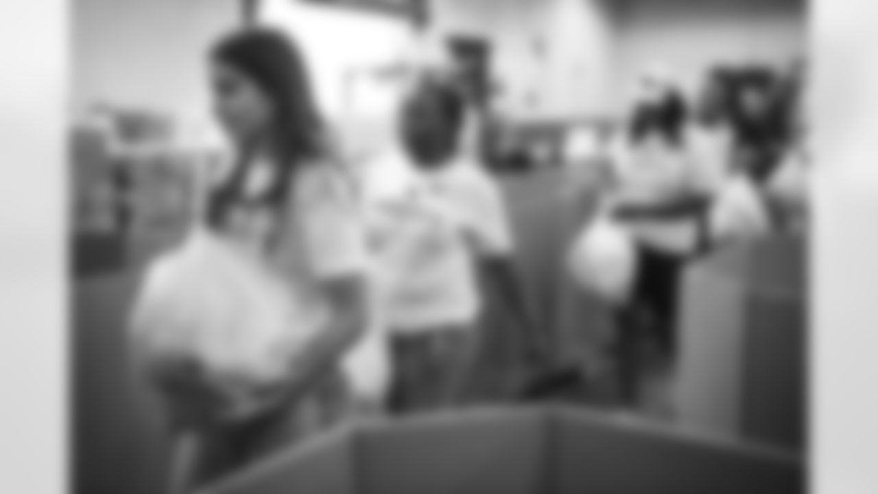 The Arizona Cardinals Women's Club packs emergency food bags at United Food Bank on Thursday, November 16, 2023 in Mesa, AZ.