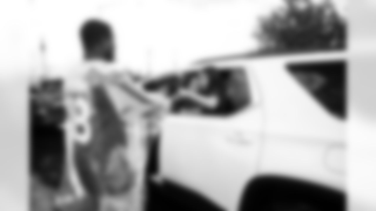 Arizona Cardinals offensive lineman Kelvin Beachum (68) and Arizona Cardinals offensive lineman Paris Johnson Jr. (70) host a food distribution for families at the Eisenhower Center for Innovation in collaboration with United Food Bank on Tuesday, Nov. 18, 2025 in Mesa, AZ.