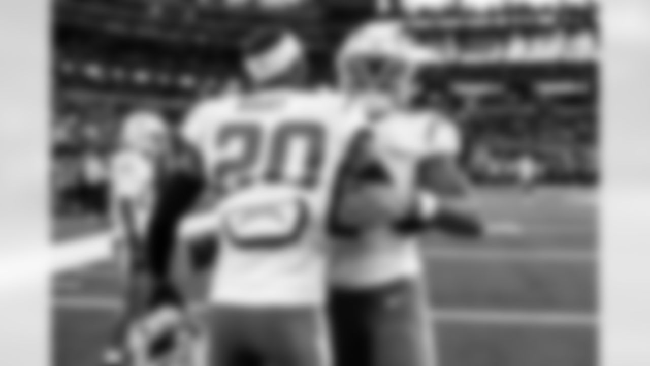 CB Cam Hart (20) and LB Daiyan Henley (0)