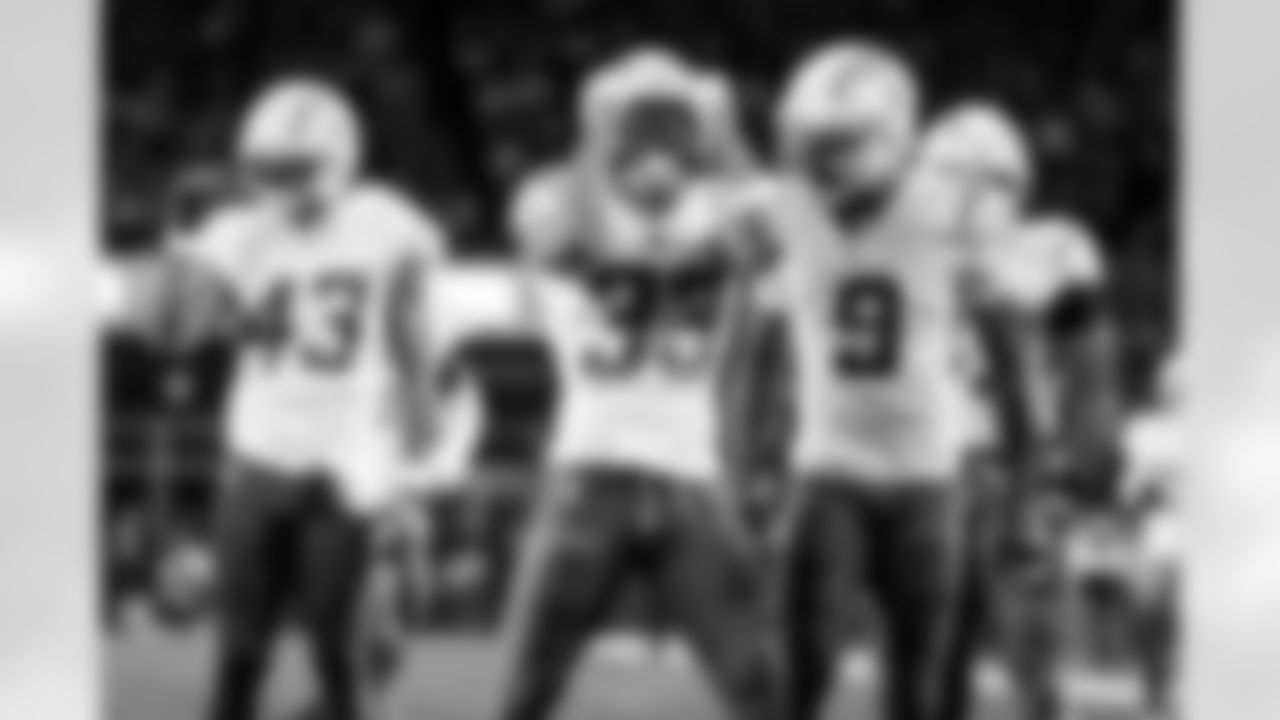 DB Deane Leonard (33) and WR Tre Harris (9)