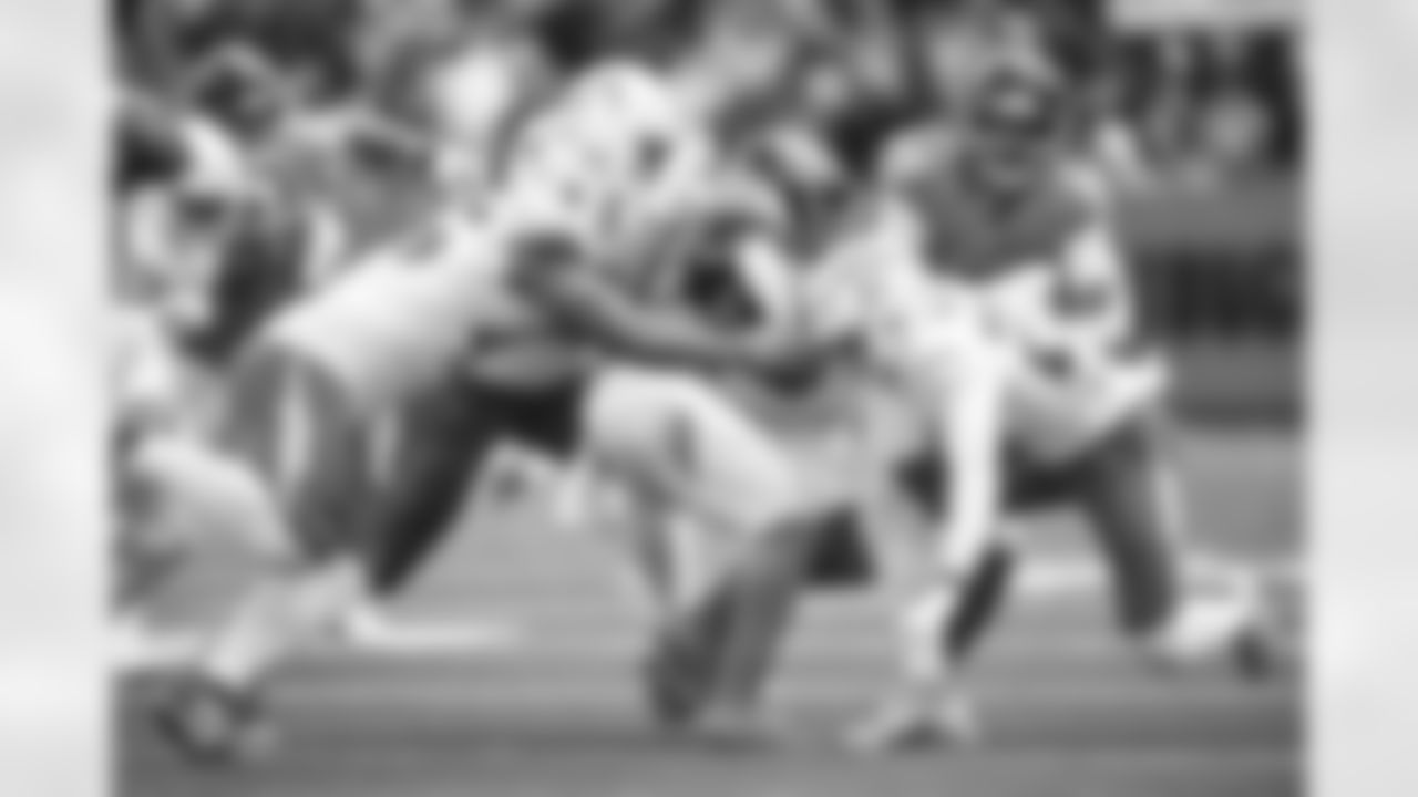 OLB Tuli Tuipulotu (45) and S RJ Mickens (27)