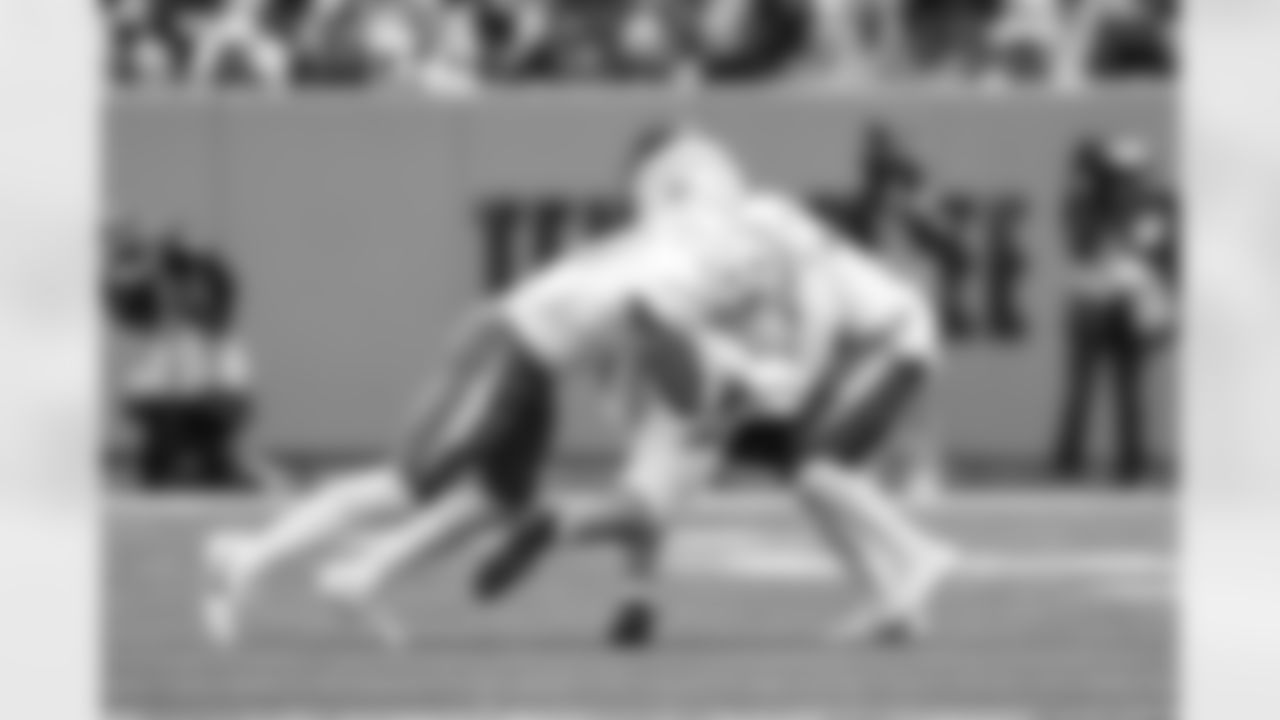 CB Nikko Reed (46) and LB Daiyan Henley (0)