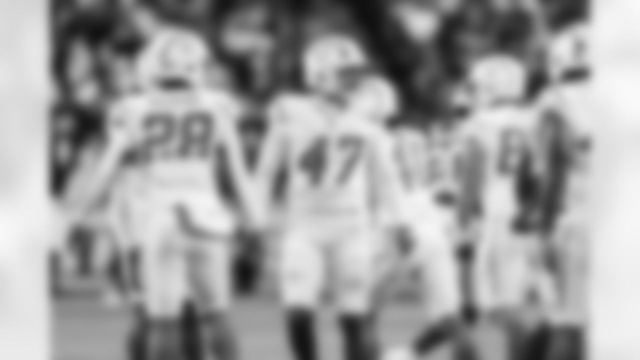 RB Hassan Haskins (28) and LS Josh Harris (47)