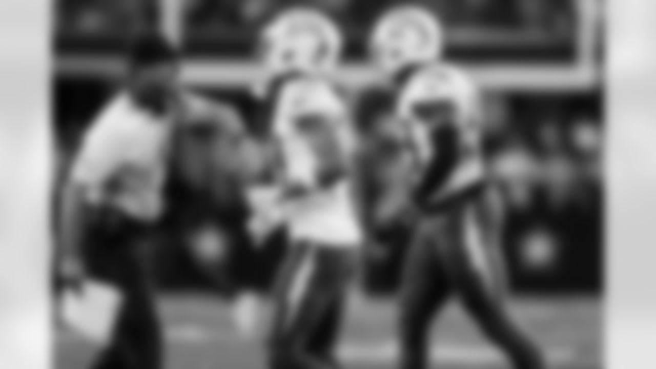 Head Coach Jim Harbaugh, DB Deane Leonard (33) and LB Del'Shawn Phillips (53)