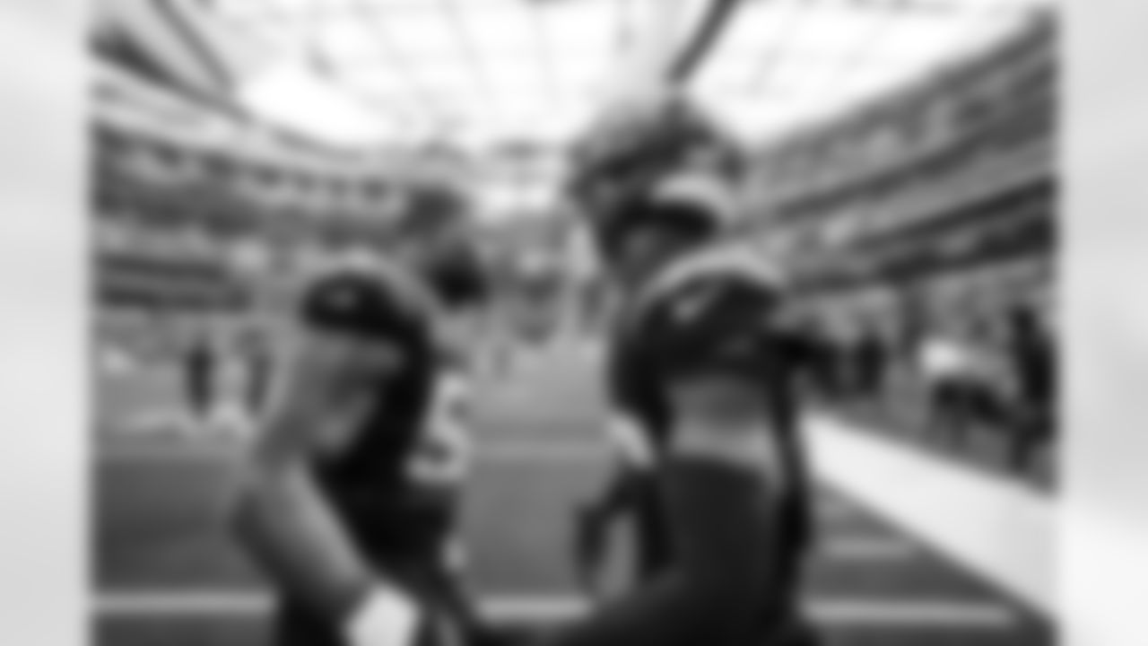 OLB Khalil Mack (52) and CB Cam Hart (20)