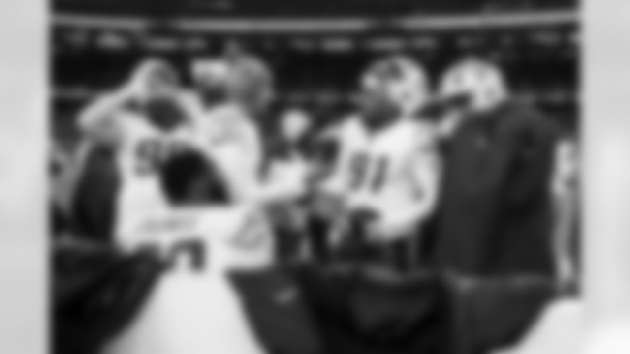 DL Da'Shawn Hand (91) and P JK Scott (16)