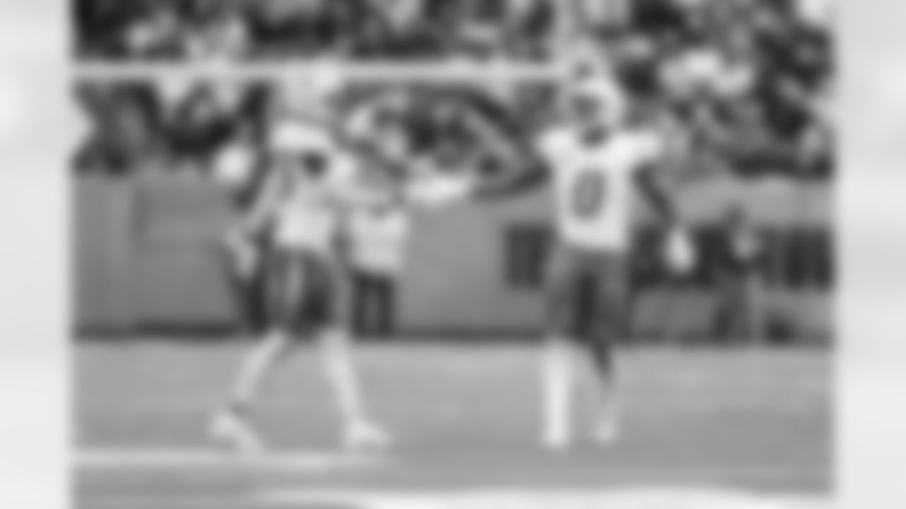 CB Cam Hart (20) and LB Daiyan Henley (0)