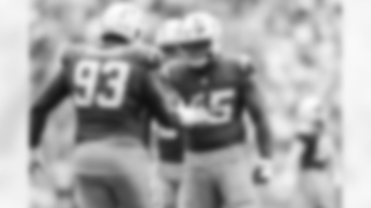 DL Otito Ogbonnia (93) and OLB Tuli Tuipulotu (45)