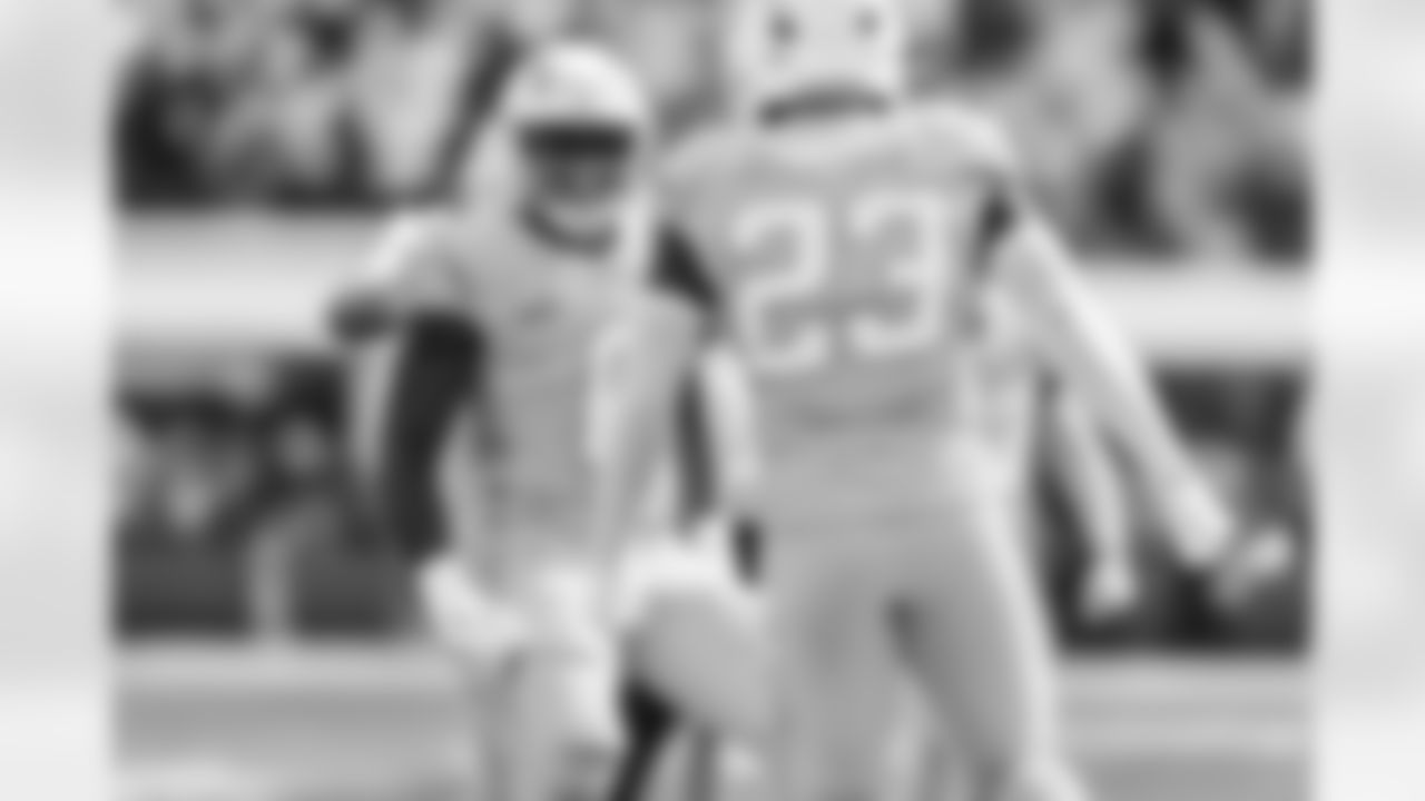LB Daiyan Henley (0) and S Tony Jefferson (23)