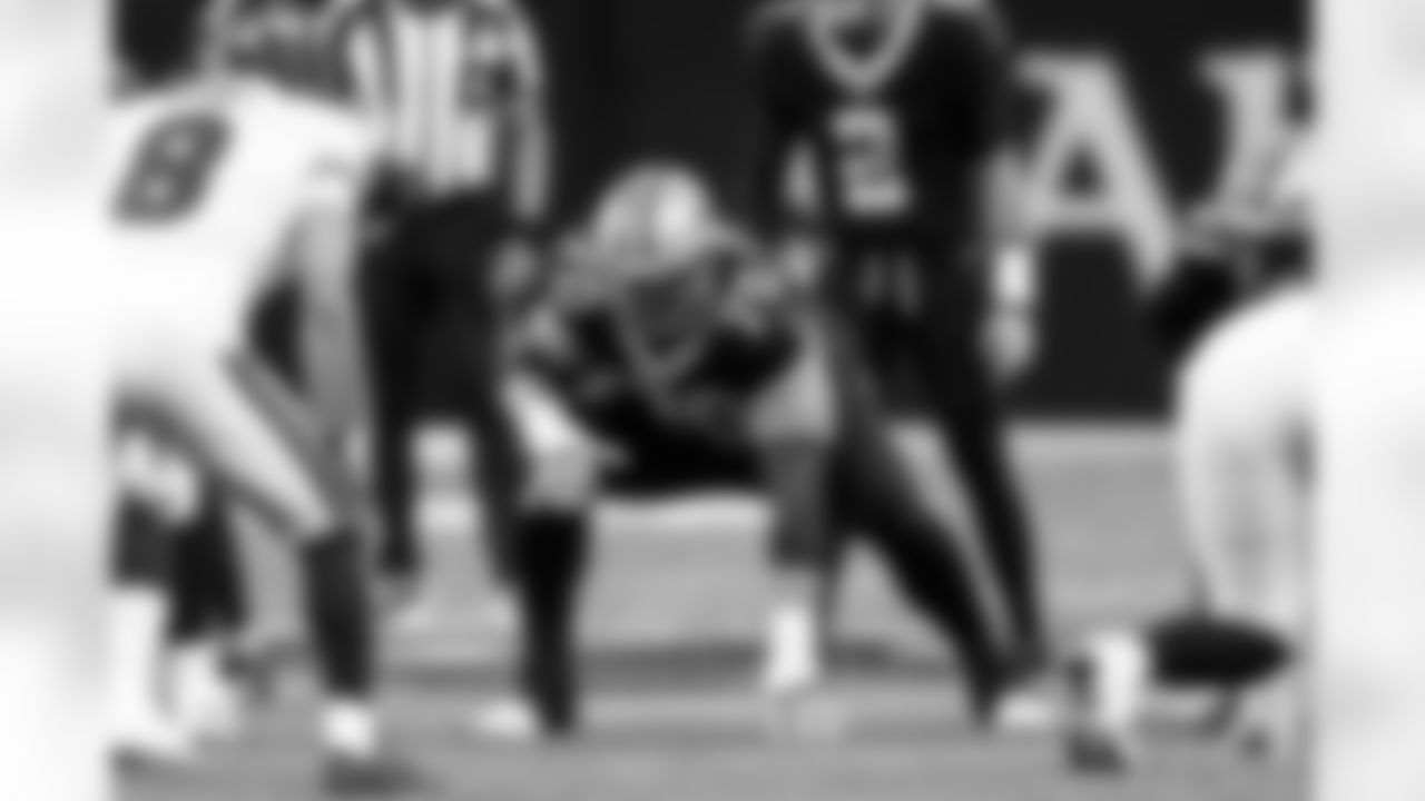 New Orleans Saints offensive tackle Trevor Penning (70) lines up for a play as quarterback Spencer Rattler (2) calls out from the line scrimmage in the first half of an NFL football game against the Tampa Bay Buccaneers, Sunday, Oct. 26, 2025, in New Orleans. (AP Photo/Gerald Herbert)