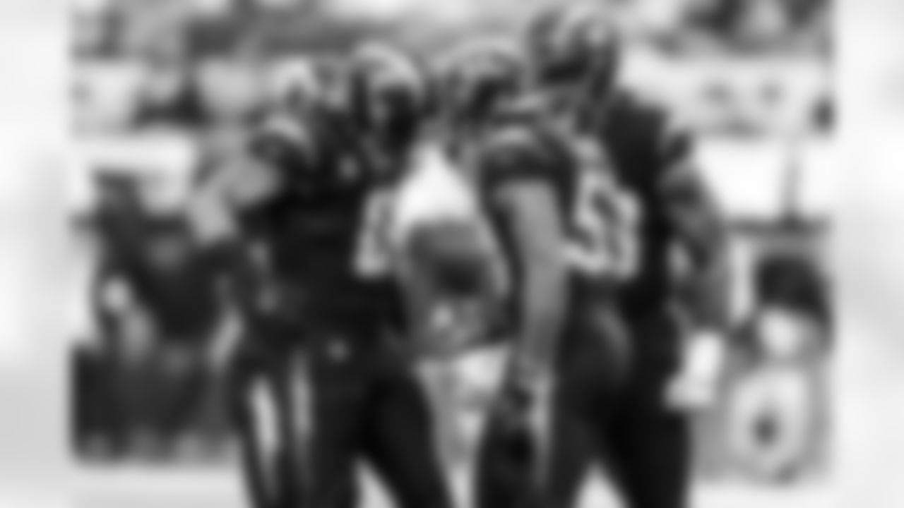 LB Daiyan Henley (0) and LB Del'Shawn Phillips (53)