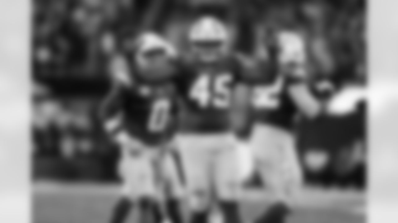 LB Daiyan Henley (0) and OLB Tuli Tuipulotu (45)