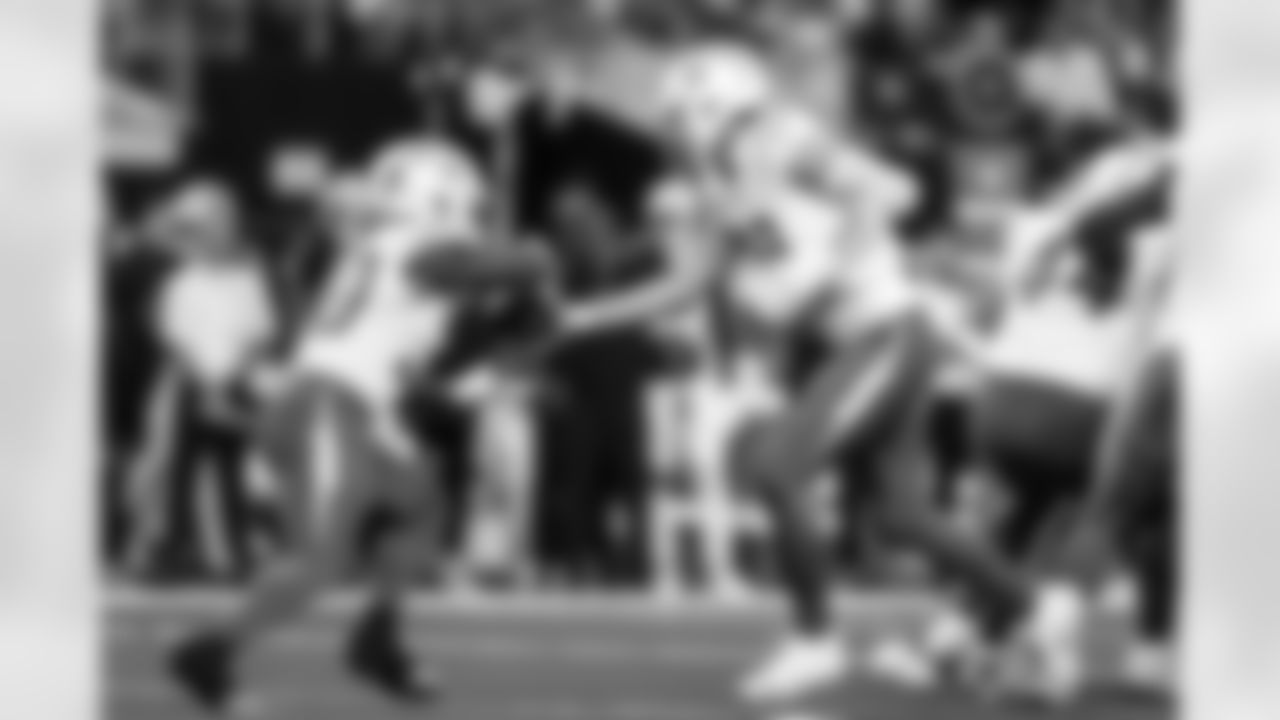 RB Kimani Vidal (30) and QB Justin Herbert (10)