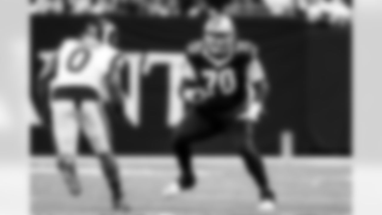 New Orleans Saints offensive tackle Trevor Penning (70) defends against Los Angeles Rams linebacker Byron Young (0) during an NFL football game, Sunday, Dec. 1, 2024, in New Orleans. (AP Photo/Tyler Kaufman)