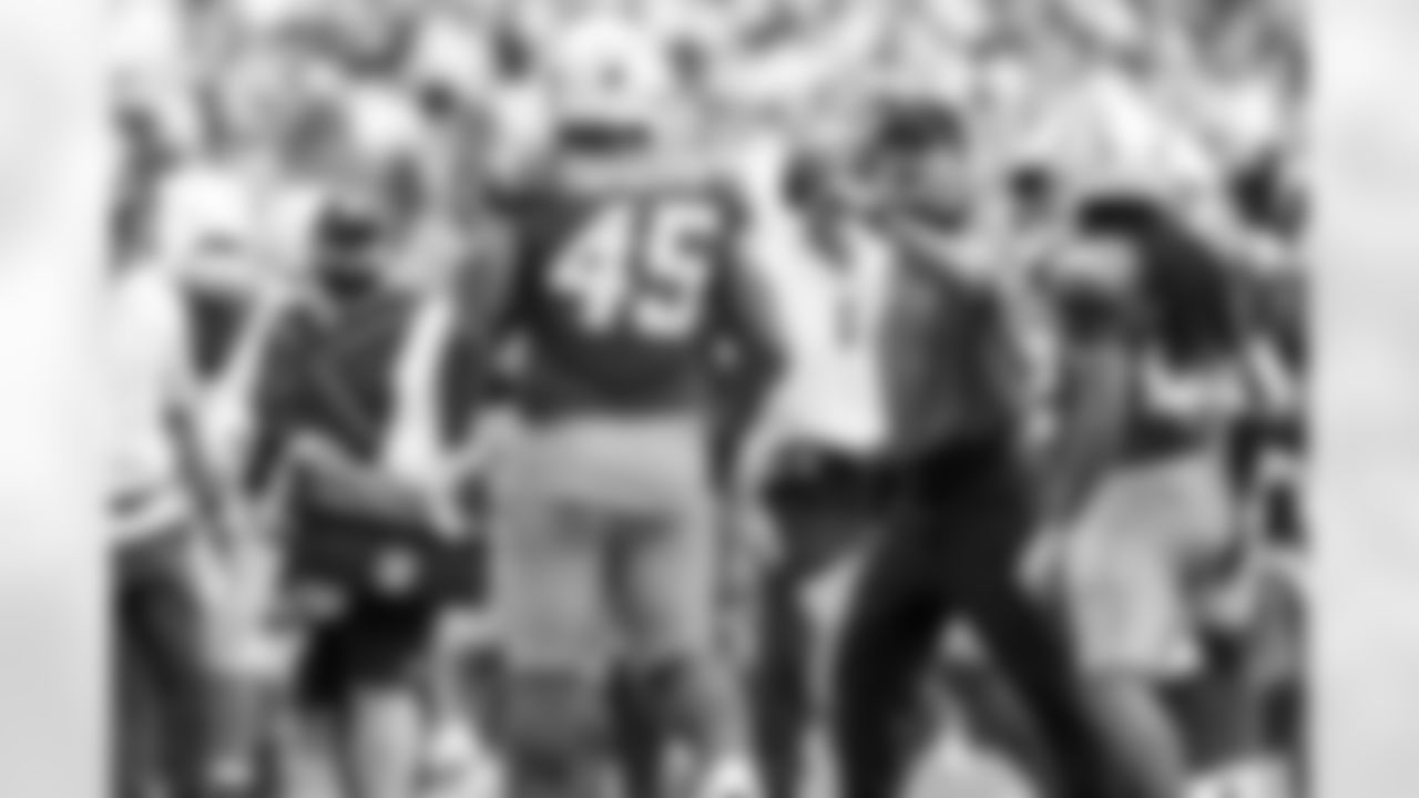 OLB Tuli Tuipulotu (45) and Head Coach Jim Harbaugh