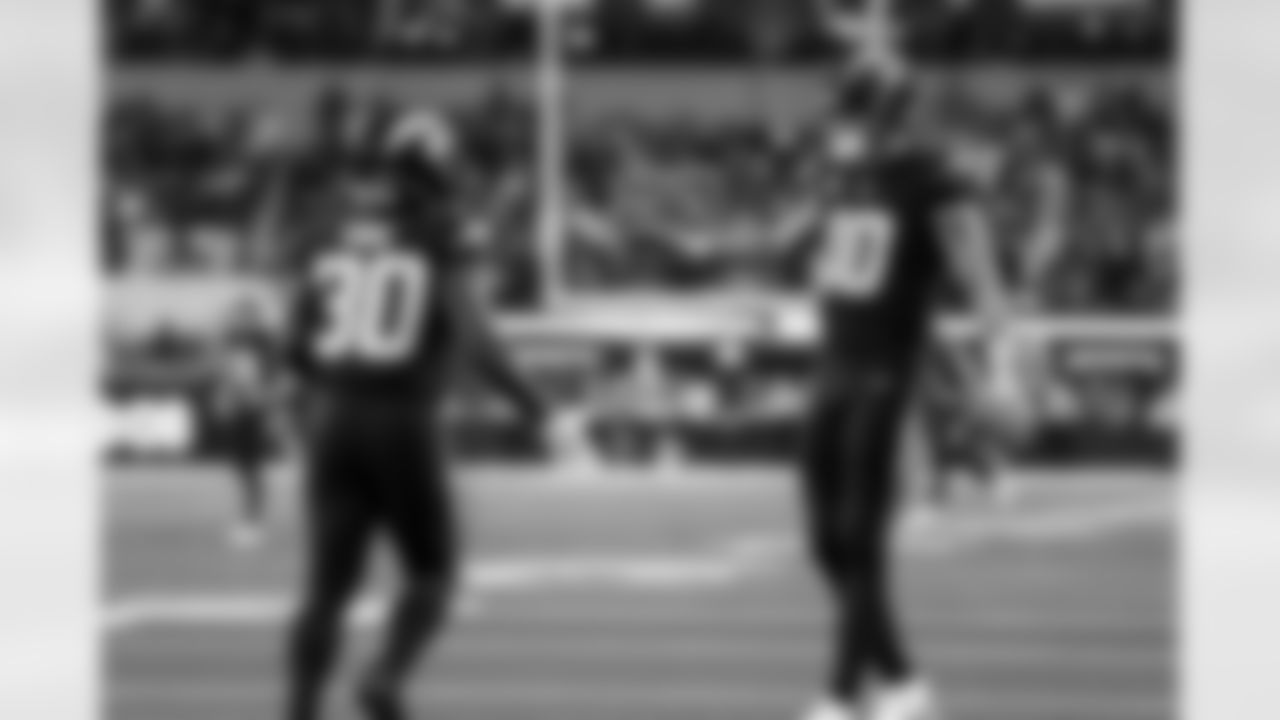 RB Kimani Vidal (30) and QB Justin Herbert (10)