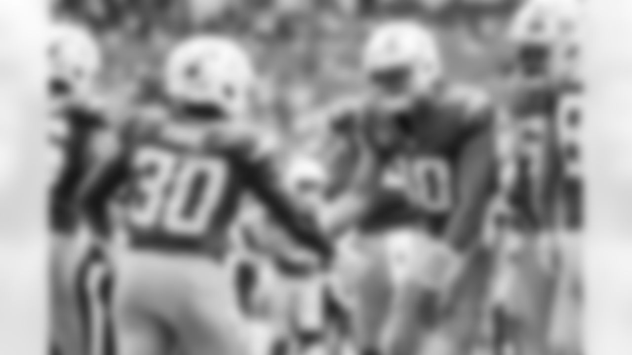 RB Kimani Vidal (30) and QB Justin Herbert (10)