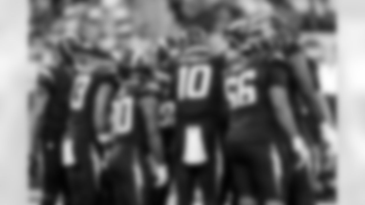 QB Justin Herbert (10), T Bobby Hart (66) and RB Kimani Vidal (30)