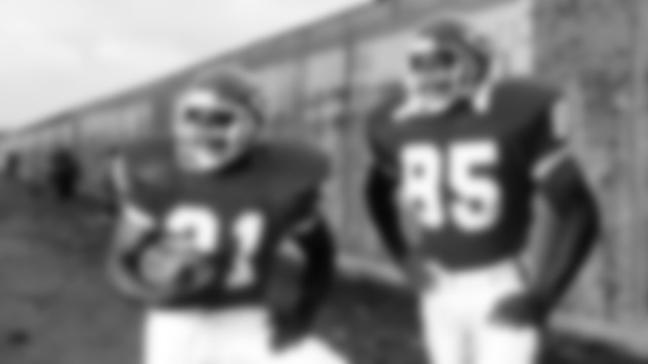 Kansas City Chiefs running back James Saxon (21) and tight end Johnathan Hayes (85) pose at the Berlin Wall in 1990.