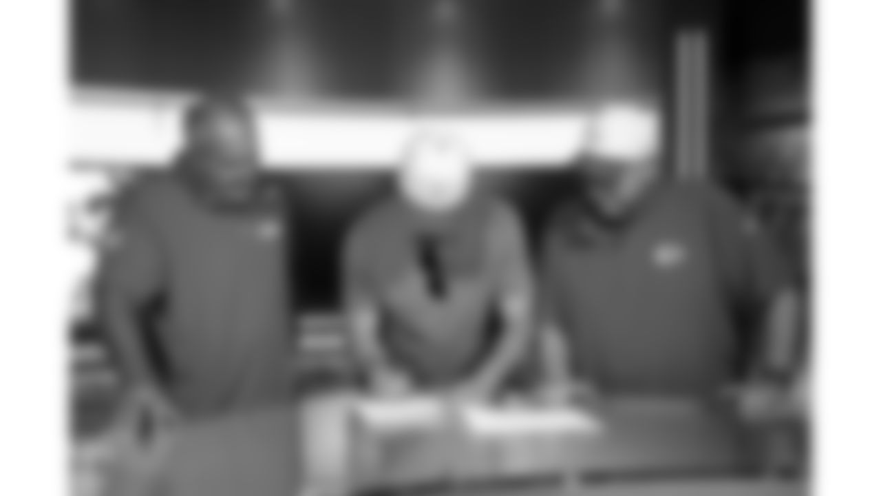 Former Kansas City Chiefs punter Dustin Colquitt signs a one-day offseason contract with head coach Andy Reid and assistant head coach Dave Toub on Wednesday, June 4, 2025 in Kansas City, MO.