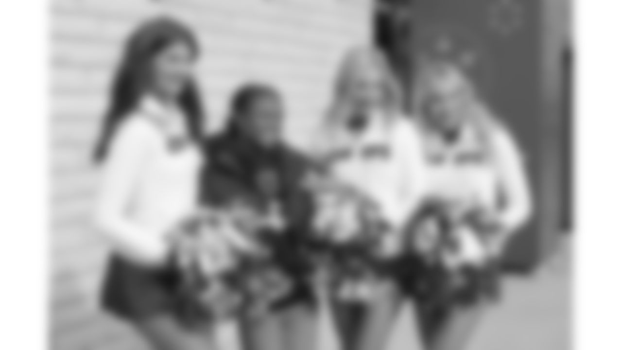 Kansas City Chiefs Cheerleaders and a fan before a week 12 NFL football game against the Indianapolis Colts, Sunday, November 23, 2025 in Kansas City, MO.