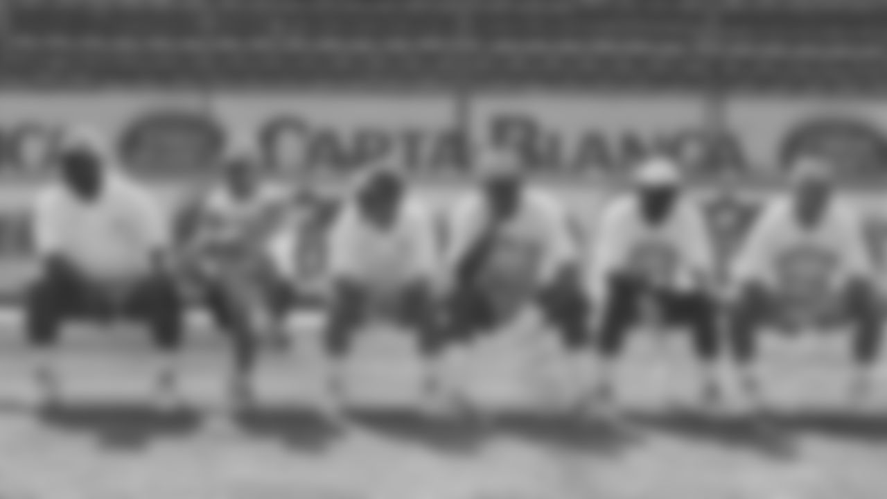 The Kansas City Chiefs coaching staff sits on the bench before a practice during the 1996 preseason trip to Monterrey, Mexico.