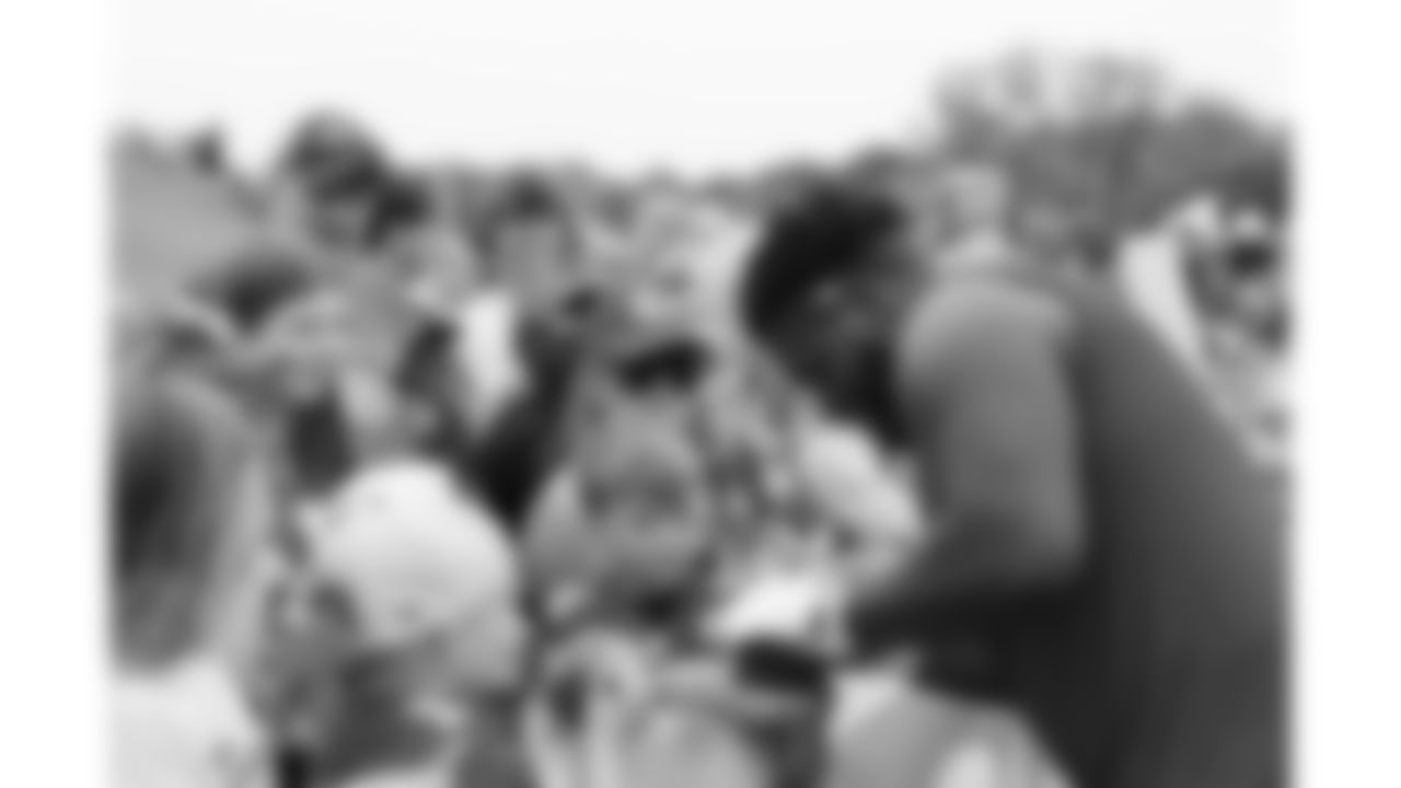 Kansas City Chiefs offensive lineman Jaylon Moore (77) signs fan merchandise after day 11 of Training Camp practice on Sunday, August 3, 2025.