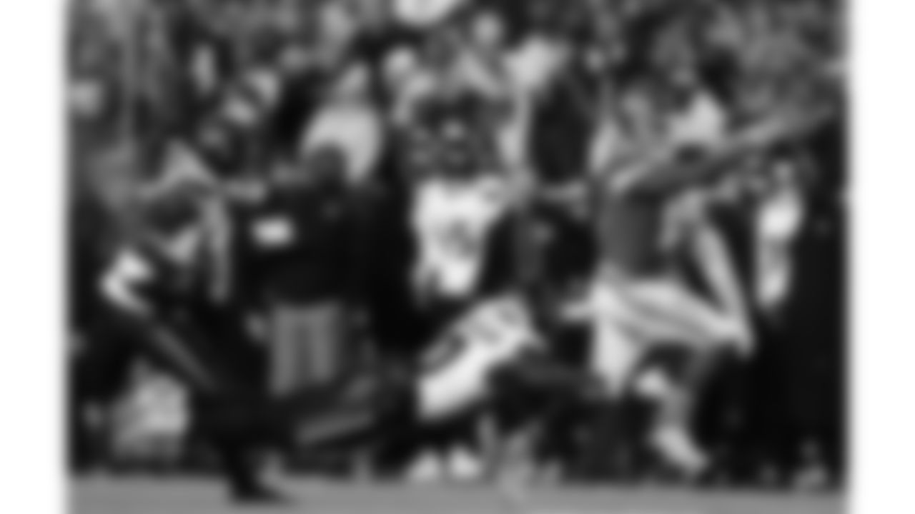 Kansas City Chiefs quarterback Patrick Mahomes (15) scrambles with the ball as a Texans player attempts to tackle him during a week 14 NFL football game against the Houston Texans, Sunday, December 7, 2025 in Kansas City, MO.