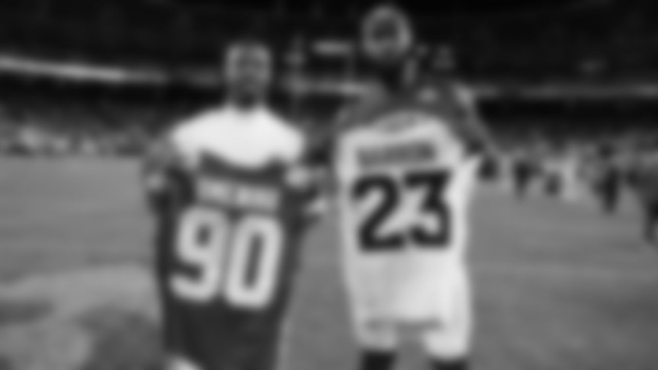 Kansas City Chiefs defensive end Charles Omenihu (90) swaps his jersey with Denver Broncos corner back Jahdae Barron (23) after an NFL week 17 matchup against the Denver Broncos, Thursday, December 25, 2025.