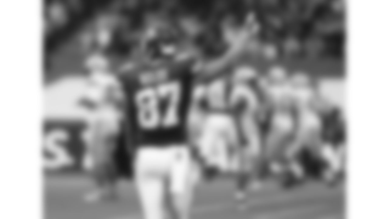 Kansas City Chiefs tight end Travis Kelce (87) points upward as he walks towards the field during the 2015 game against the Detroit Lions at Wembley Stadium in London.