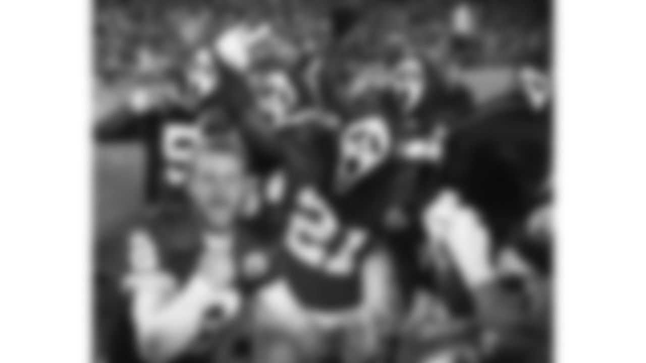 Kansas City Chiefs punter Dustin Colquitt (2) poses on the sideline with teammates wearing Scream masks during a 2011 home game.